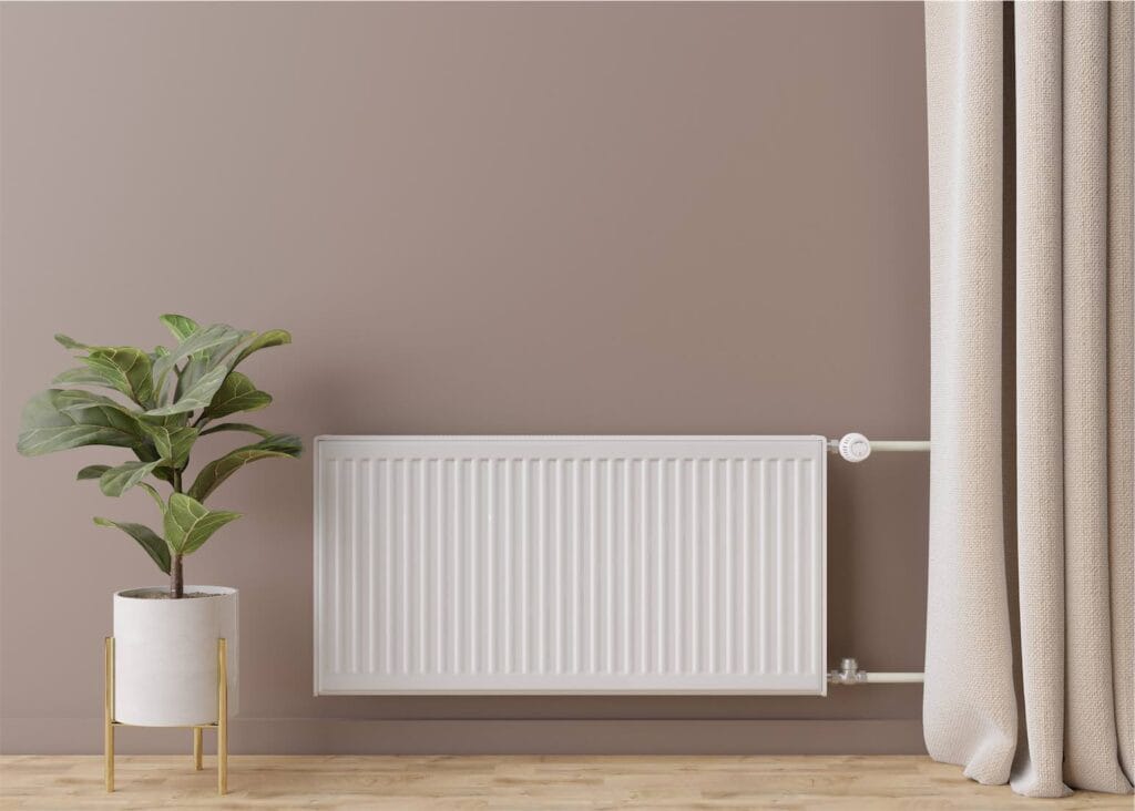 energioptimering i nordjylland - TA Varmeteknik - white heating radiator with thermostat on brown wa 2022 11 16 12 22 12 utc - Hjem